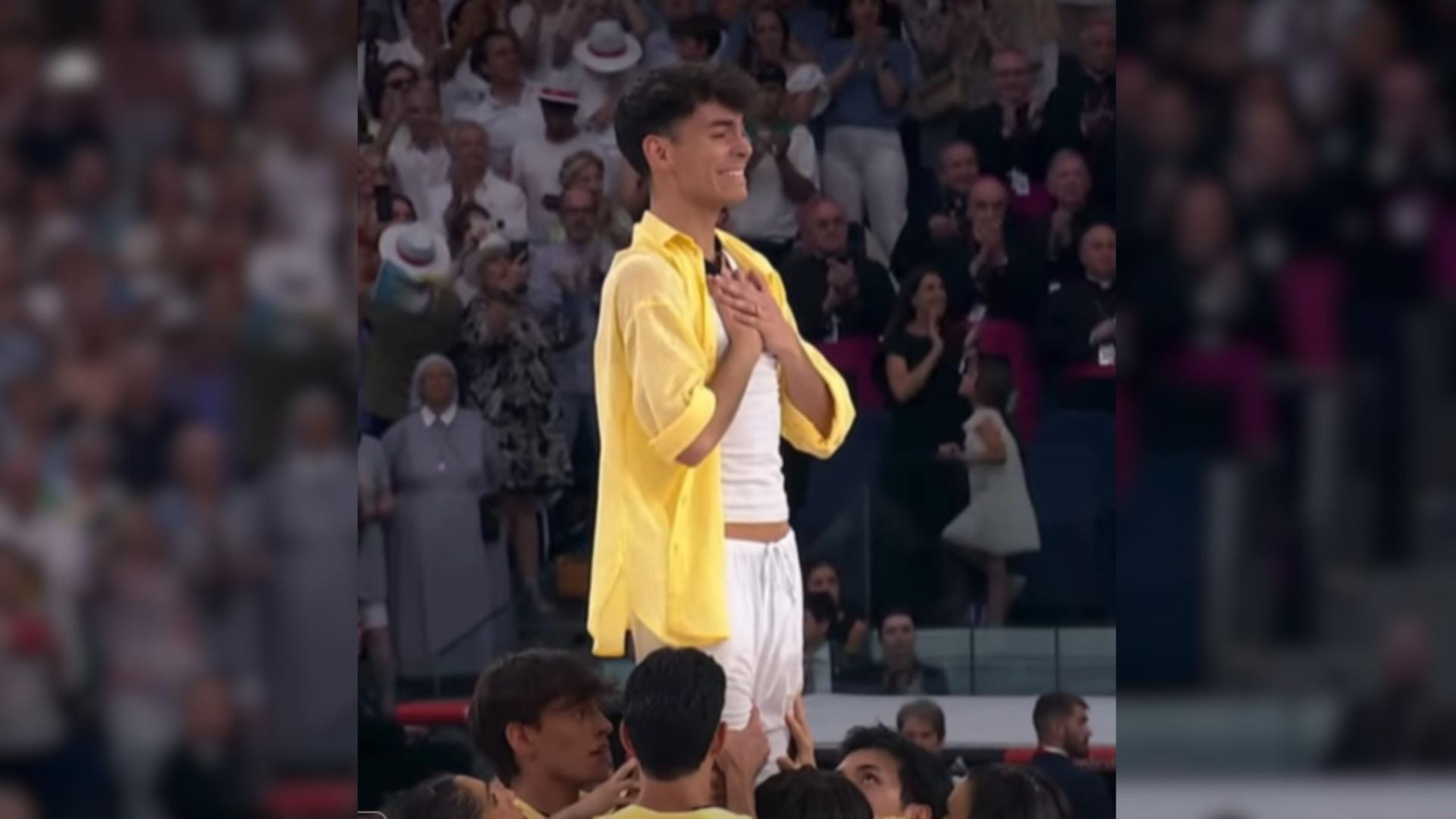 Ismael Olivas directing dancers on a stage at the Santiago Bernabéu stadium.