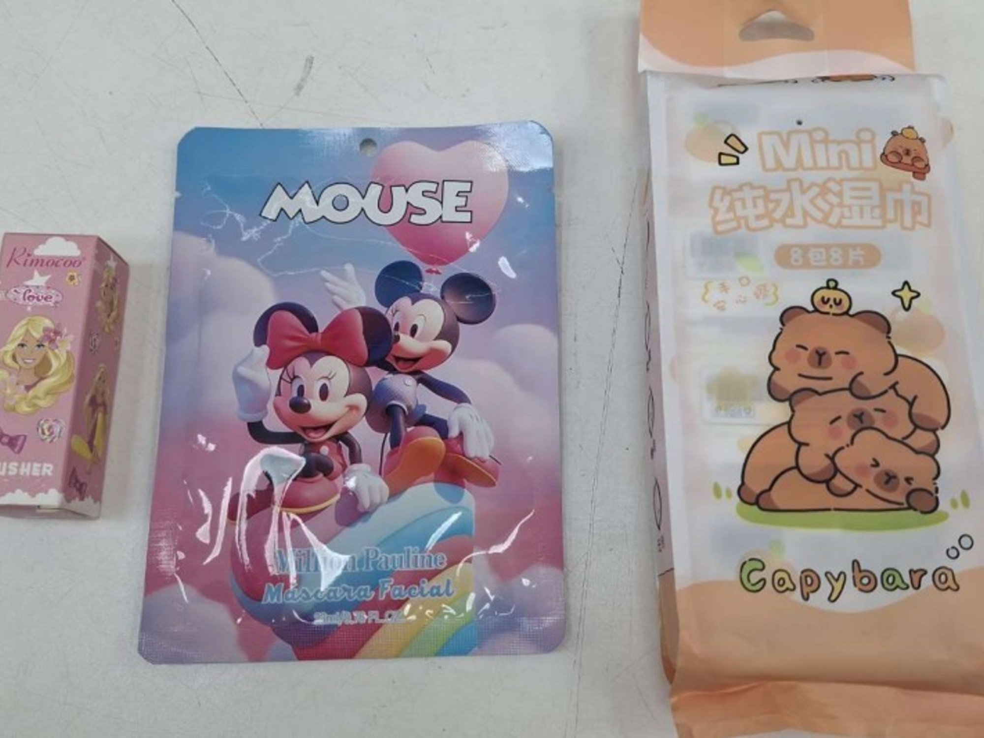 A collection of children's makeup products, including lipsticks and eyeshadow palettes.